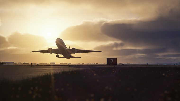 A 777 rotating into the sunset at Honolulu, its gear still down.