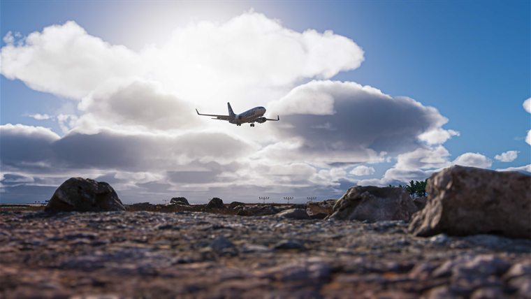 An Alaska Airlines 737 on short final, seen from the rocks before the runway at Honolulu.