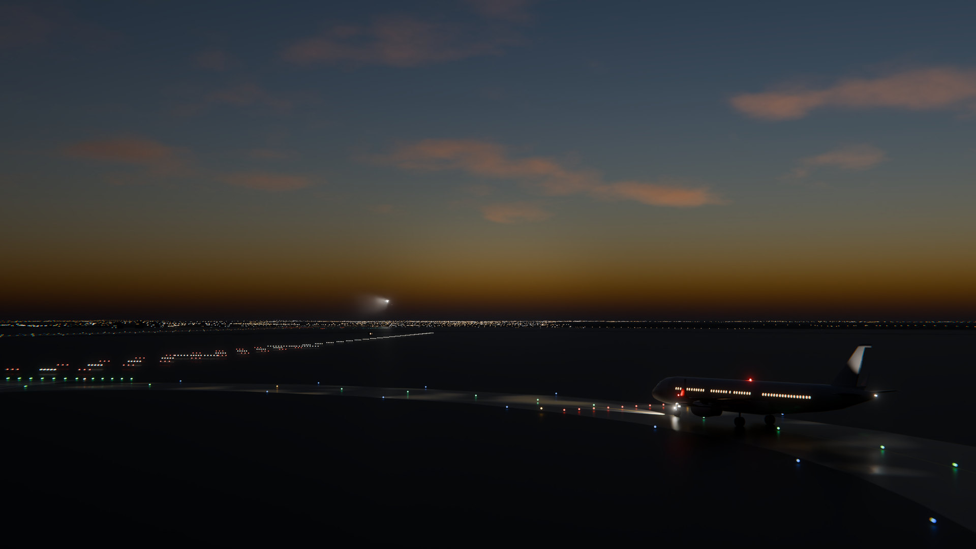 Dusk at Manchester from beside runway 05L: an airliner holds short at the runway's first entry, and an arrival is on short final